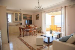 a kitchen and living room with a table and chairs at Grand View Retreat at "Avythos" Βeach in Kaligata