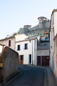 an empty street with a castle in the background at La maison rue Nadaud, au pied des remparts in Carcassonne
