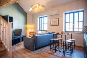 a living room with a couch and a table at La maison rue Nadaud, au pied des remparts in Carcassonne