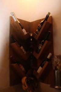 a bunch of wine bottles in a wooden holder at My Secret Home in Seminyak