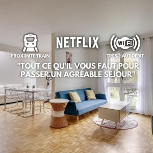 a living room with a blue couch and a table at La "Marquise", Jardin et Parking Privatif in Guyancourt