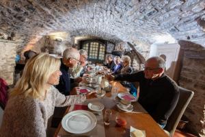 a group of people sitting at a table in a restaurant at Le Barry du Grand Chemin in Le Caylar