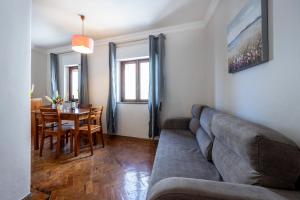 a living room with a couch and a table at Muralha Holiday Apartments in Lagos