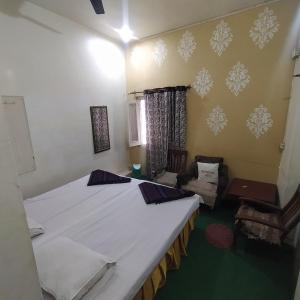 a room with two beds and a couch in it at International Hotel In in Gorakhpur