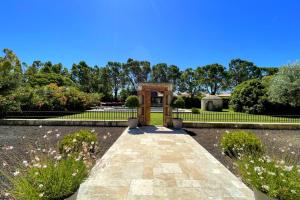 a garden with a monument in the middle of a park at Beautiful contemporary villa swimming pool and large garden in Berre-lʼÉtang