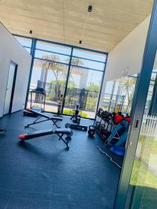a gym with cardio equipment in a large room with windows at 931 Ballito Groves in Ballito