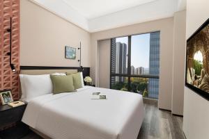 Voodi või voodid majutusasutuse Somerset Chayuan Chongqing toas