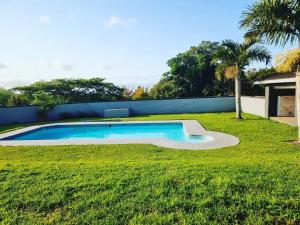 a swimming pool in the middle of a grass field at Leading Guest Farm in Margate