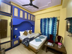 um quarto com uma cama com uma parede azul em BNB ROYAL INN SHIMLA em Shimla