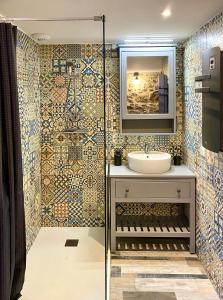 a bathroom with a sink and a mirror at #SPA Wellness @ Paris 11ème in Paris