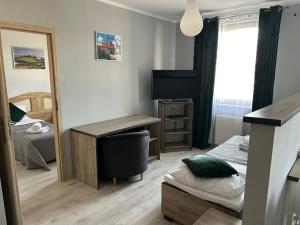 Posteľ alebo postele v izbe v ubytovaní H-T-L Apartamenty Junior
