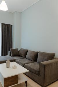 a living room with a brown couch and a table at G & K Cozy Apartments in Athens