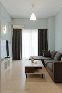 a living room with a couch and a coffee table at G & K Cozy Apartments in Athens