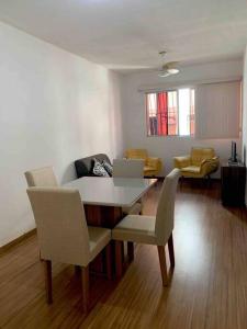 a living room with a table and chairs at Apartamento Jardim Camburi 2 quartos in Vitória