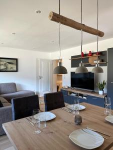 a dining room with a table and a living room at Apartment Schwinbachblick mit 2 Balkonen in St. Blasien