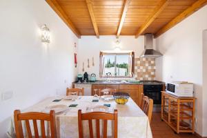 - une cuisine avec une table et des chaises dans la chambre dans l'établissement Casa Tomilho Limão, à Alvor