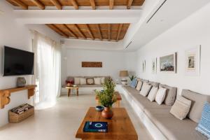 A television and/or entertainment centre at Ker Estate by Ethos Hospitality