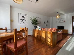 a living room with a table and a couch at Apartamento Cleo Gijón in Gijón