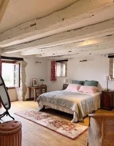 a bedroom with a large bed with a wooden ceiling at Les Hauts de Broze in Broze