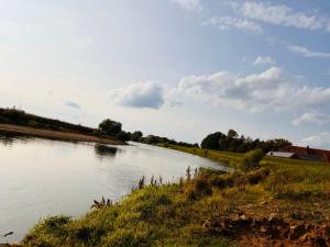 a view of a river with a house in the distance at Ferien/Monteurwohnung Hodenhagen in Hodenhagen