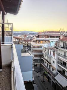 a view of a city from the balcony of a building at Zenios Alexandros - Traditional penthouse in Oia