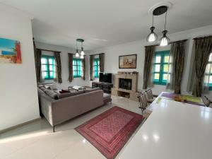 a living room with a couch and a table at Castello Marmaris Holiday Home in Marmaris