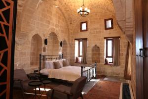 a bedroom with a bed in a stone building at Zabel Hotel in Mardin