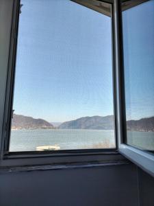 a window with a view of a body of water at Apartament Home Comfort in Orşova +5 photos
