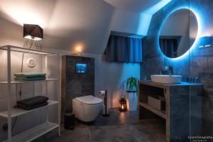 a bathroom with a sink and a toilet and a mirror at Bunkier House in Niedźwiada +265 photos
