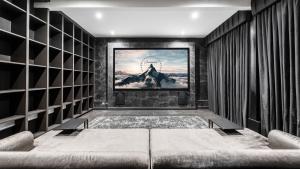a living room with a movie screen on the wall at Luxury 10,000 Sq Ft 7-bed Mansion With Indoor Pool in Sidcup