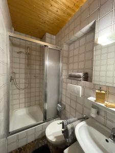 e bagno con doccia, servizi igienici e lavandino. di Ferienwohnung "Beim Henser" a Wallgau