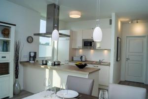 ペルツァーハケンにあるApartment Südkap C 05のキッチン(テーブル、椅子、カウンター付)