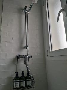 a group of wine bottles on a rack in a shower at Sol del Este in Es Castell