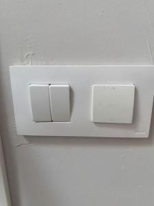 a white lightswitch on the wall of a refrigerator at Studio in Barrio Salamanca (D) in Madrid