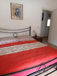 1 dormitorio con 1 cama con manta roja en Tra Mare e Pineta, en Viareggio