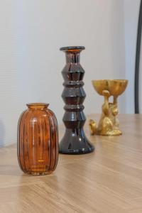 a group of vases sitting on top of a table at Cozy Parisian Retreat in the Heart of the City in Paris