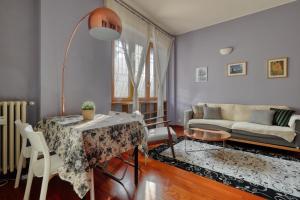 a living room with a table and a couch at Ample Apartment with private parking in Milan