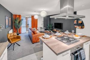 a kitchen and living room with a stove top oven at Sleek City Living with Bicocca Stays in Aberdeen