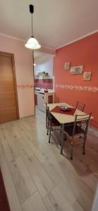 a kitchen and dining room with a table and chairs at Sweet Home Cefalù in Cefalù