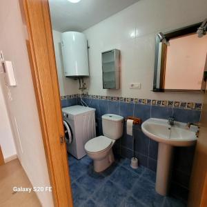 a bathroom with a toilet and a sink at apartamento llandells casa kiko in Peniscola