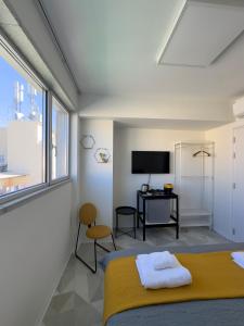 Dormitorio con cama, escritorio y TV en MARTIN Nicosia City Suites en Nicosia