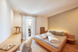 Ένα ή περισσότερα κρεβάτια σε δωμάτιο στο Alpimena Natur-Apartments Meran +42 φωτογραφίες