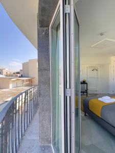 MARTIN Nicosia City Suites في نيقوسيا: غرفة مع شرفة مع سرير