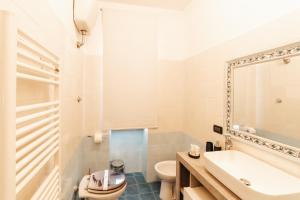 a bathroom with a sink and a toilet and a mirror at CR32 TOURIST ACCOMODATION in Civitavecchia