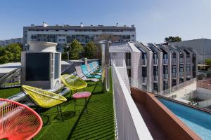 a balcony with chairs and a pool on a building at StudentVille Central in Lisbon