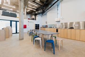 a cafeteria with tables and chairs in a kitchen at StudentVille Central in Lisbon