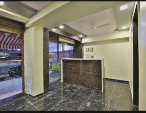 a large room with a stone fireplace in the middle at HOTEL SUNWAY in Ahmedabad