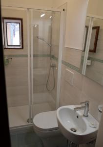a bathroom with a shower and a toilet and a sink at STELLA HOUSE in Porto Santo Stefano