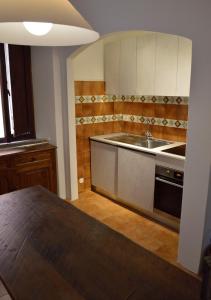 a kitchen with a sink and a stove at STELLA HOUSE in Porto Santo Stefano +9 photos