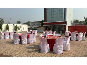 a group of chairs and a table with red and white at Hotel Nalanda Inn Bihar in Nalanda